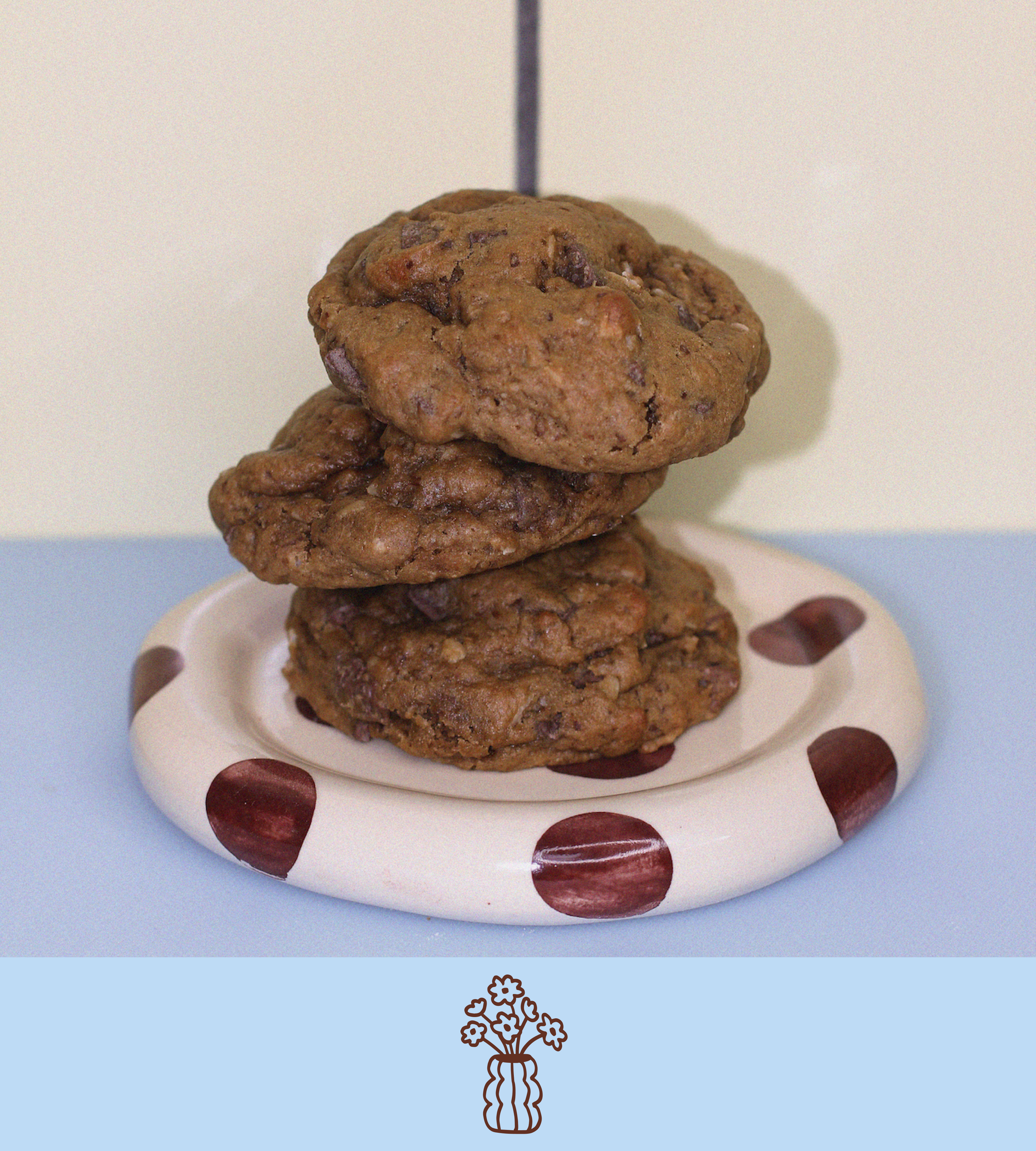 Stack of chocolate chip lactation cookies on a polka dot plate with a plain background