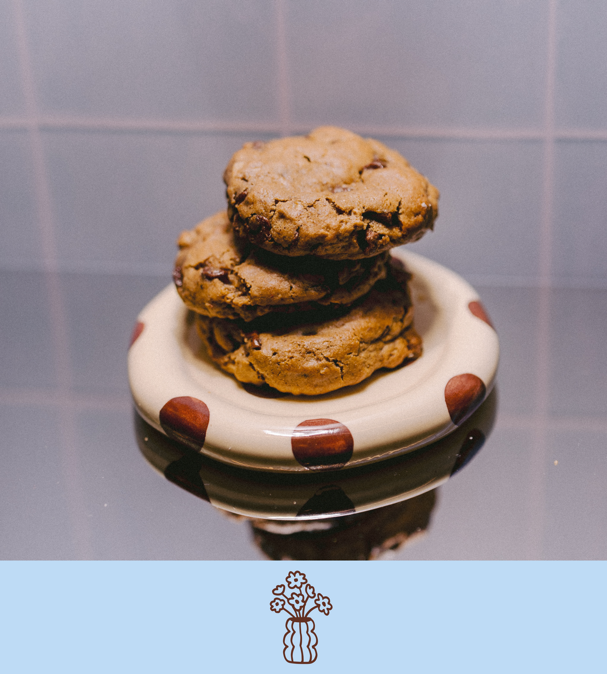Stack of chocolate chip lactation cookies on a polka dot plate with a plain background
