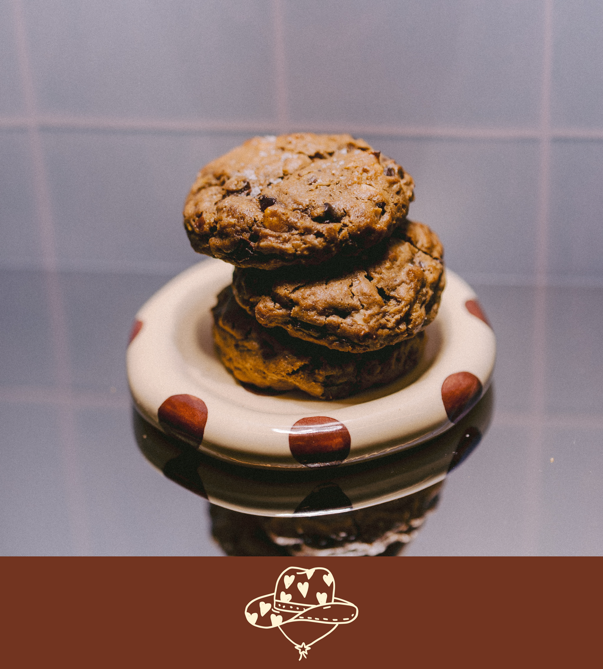 Stack of cowgirl lactation cookies on a polka dot plate with a plain background