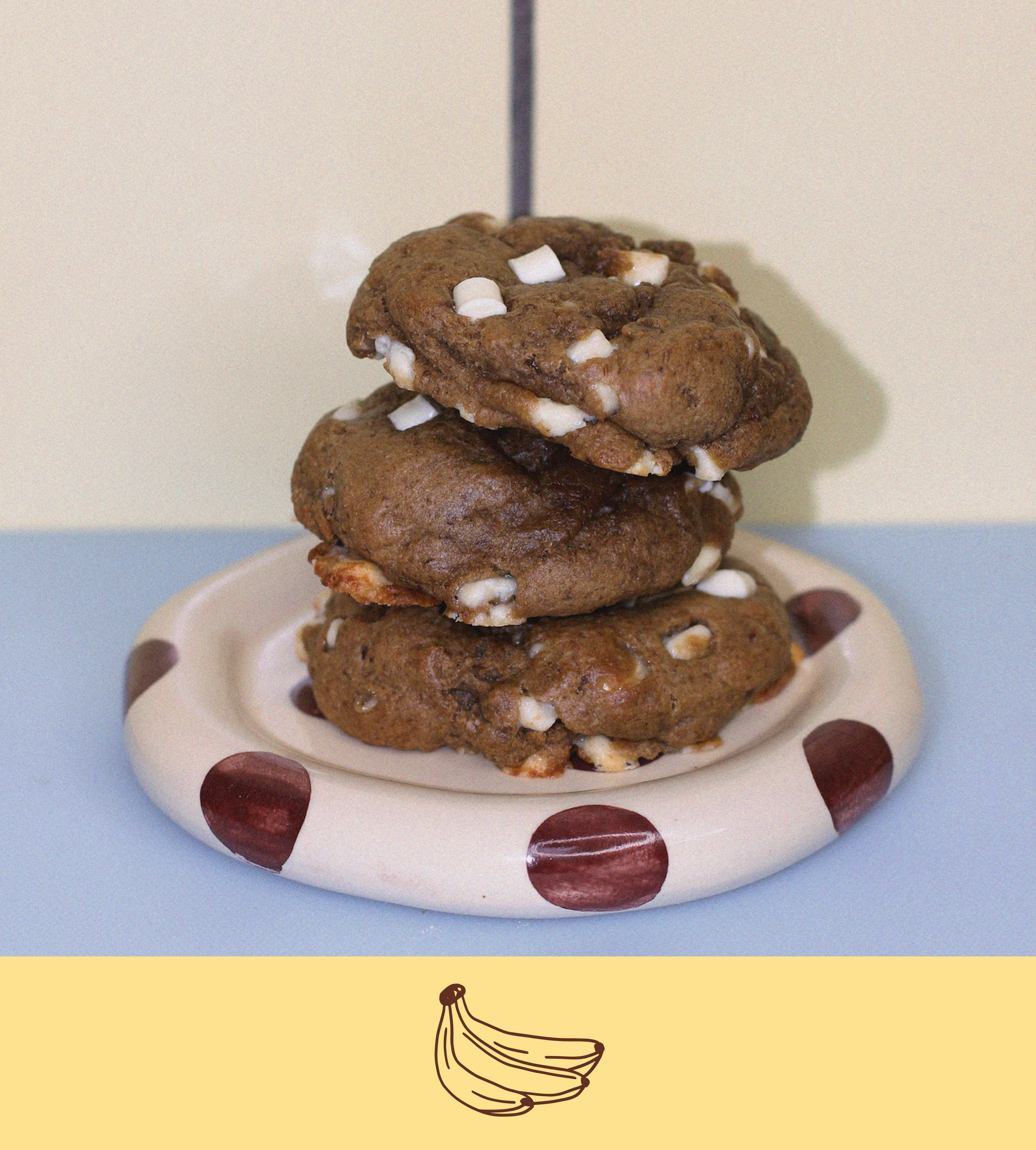 Stack of banana pudding lactation cookies on a polka dot plate with a plain background