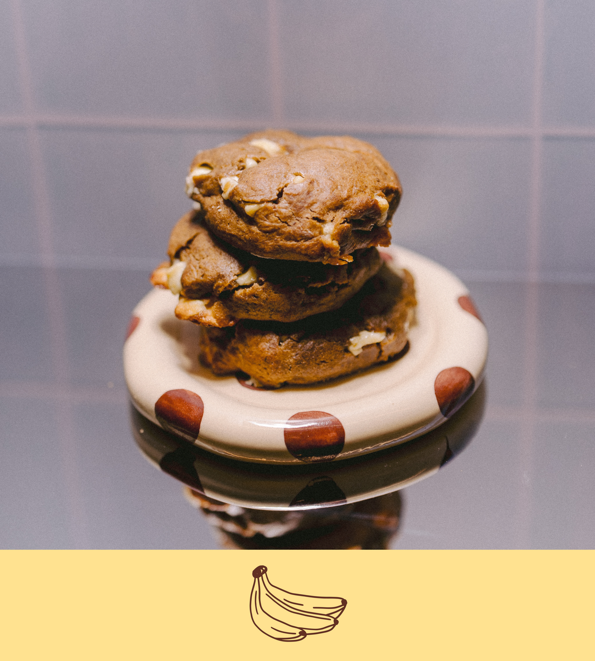 Stack of banana pudding lactation cookies on a polka dot plate with a plain background