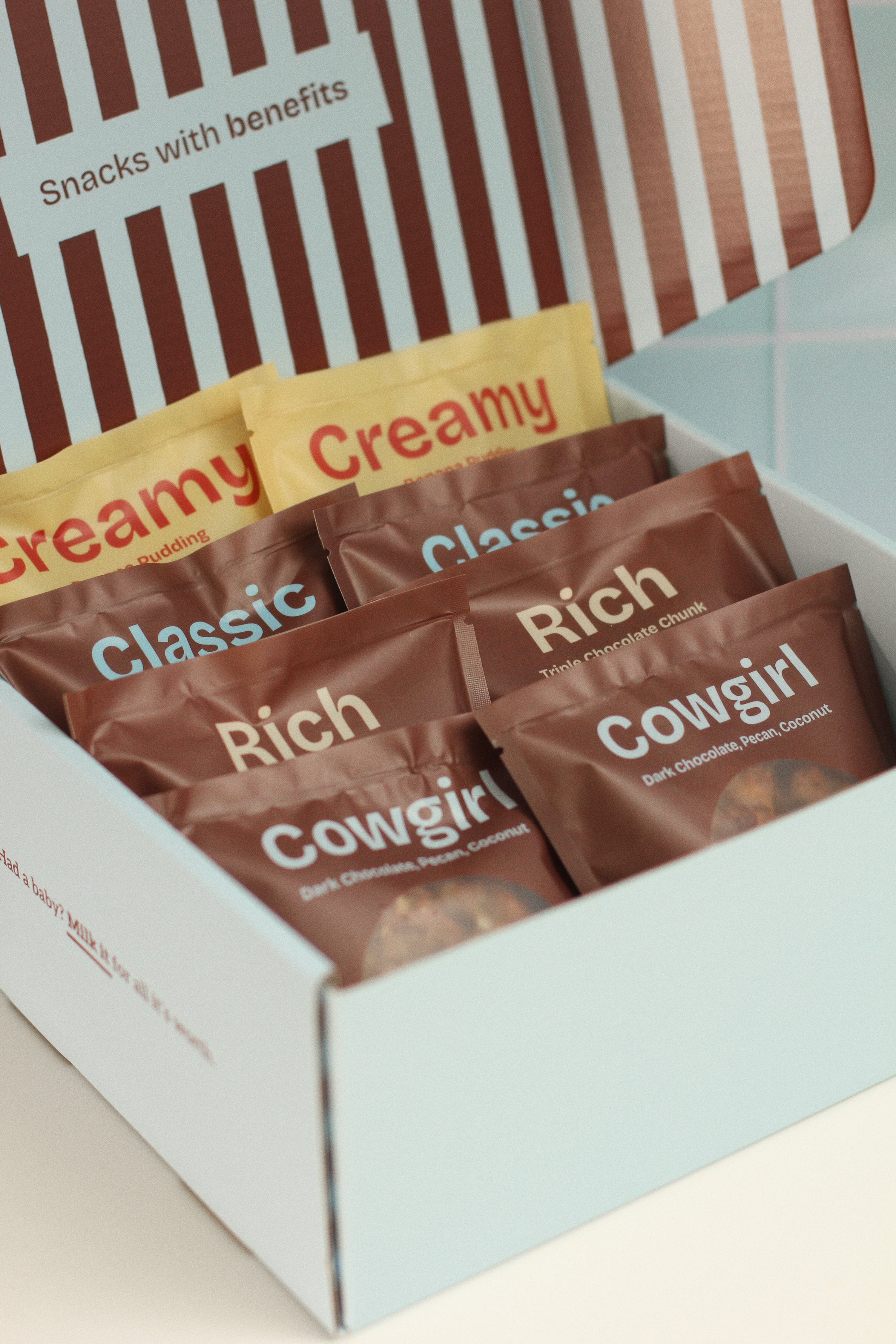 Close-up of Milk it lactation cookies in their packaging and boxed up ready to gift.   