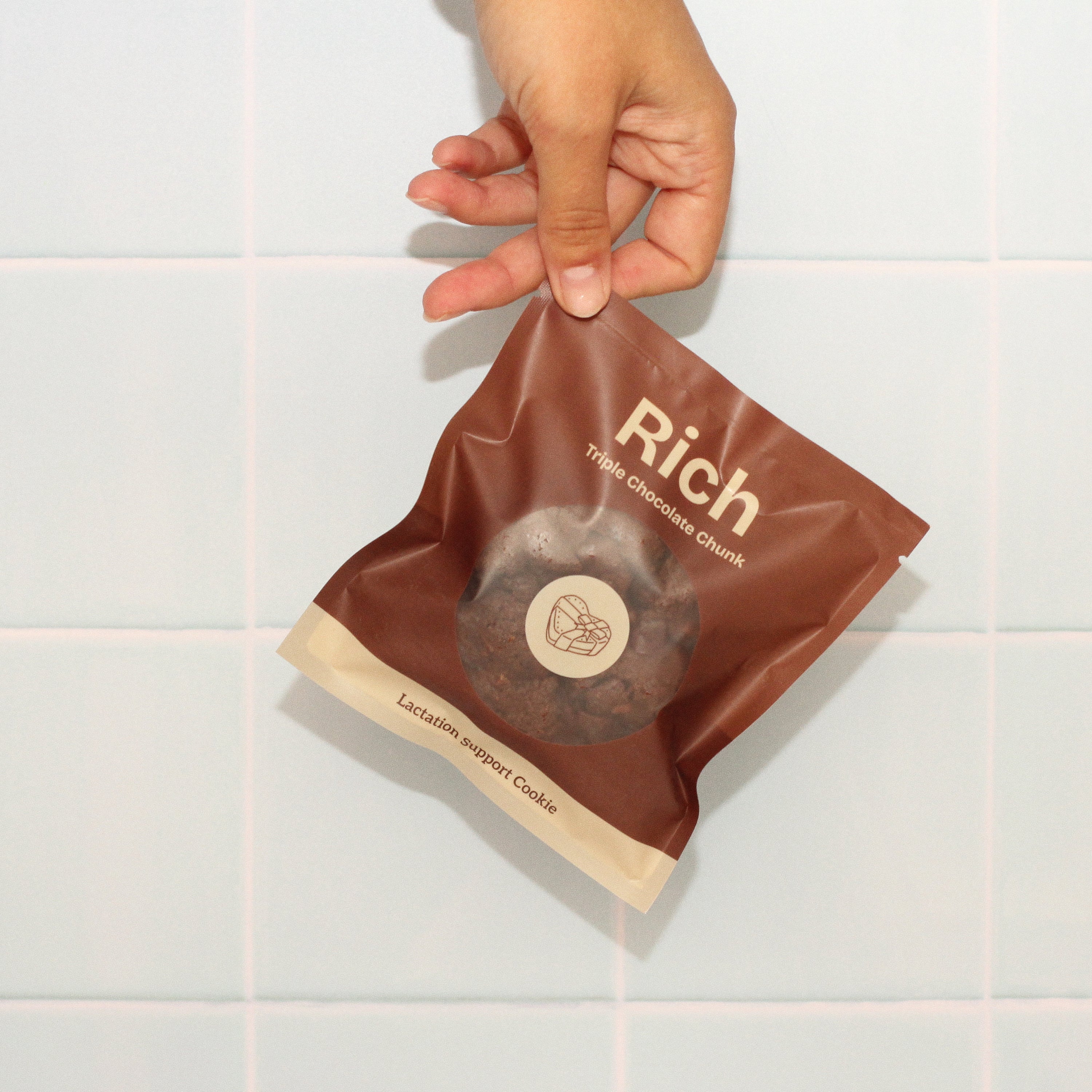 Close-up of Milk it lactation cookie with branded bag in rich triple chocolate chunk flavour– breastfeeding snack made with oats, flaxseed, and brewer’s yeast