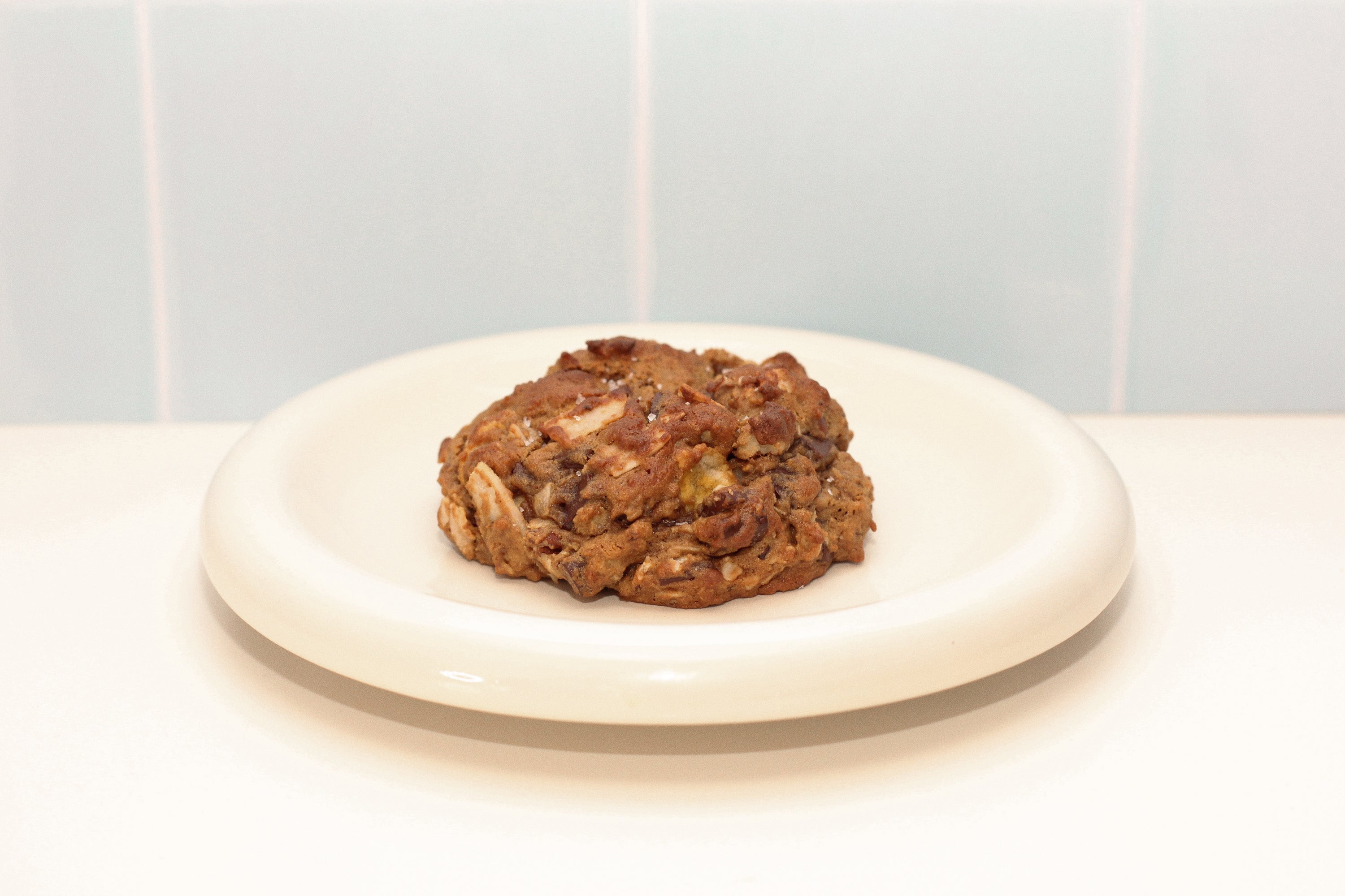 Close-up of Milk it Cowgirl pecan coconut and dark chocolate lactation cookie – breastfeeding snack made with oats, flaxseed, and brewer’s yeast