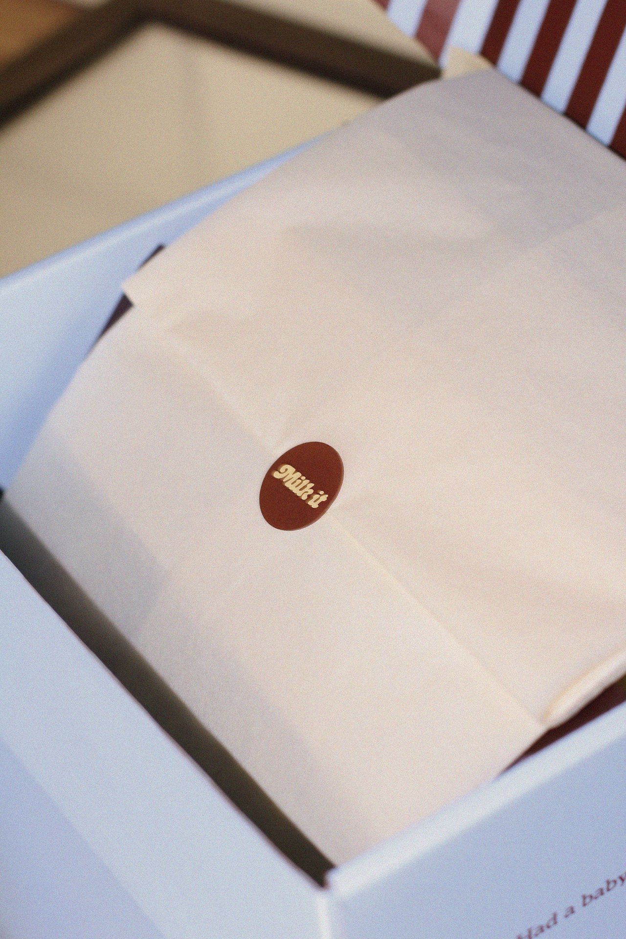 Lactation cookies wrapped in butter yellow tissue with a Milk it sticker