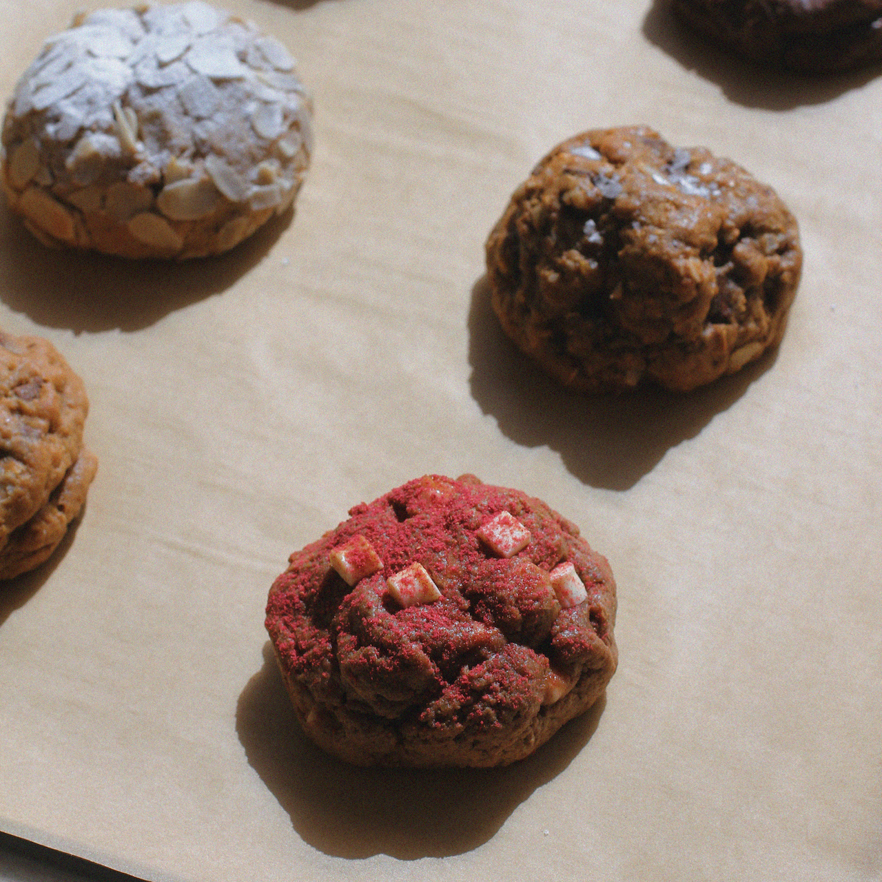 Several baked lactation suppor cookies arranged on parchment paper fresh out of the oven.