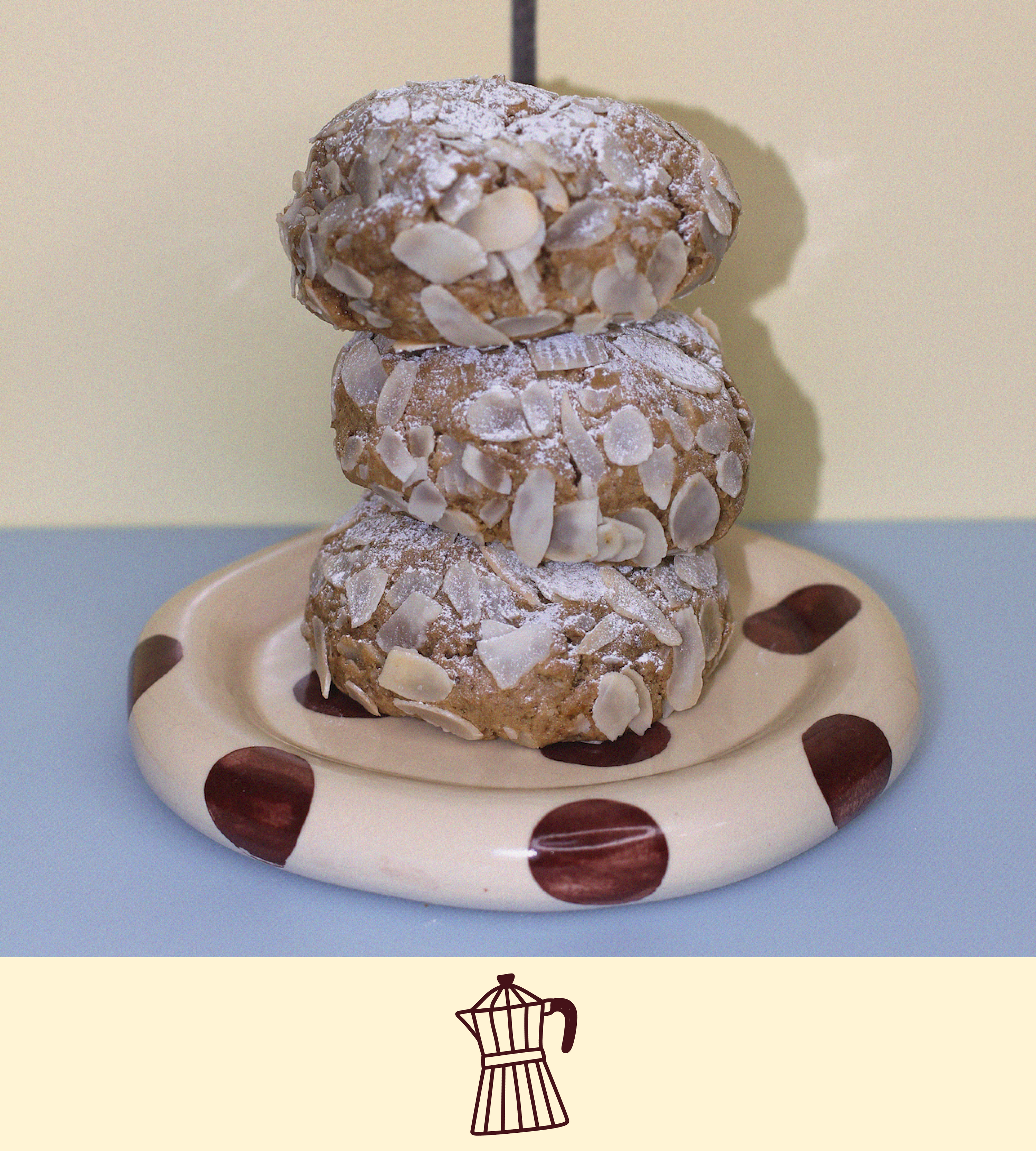 Stack of almond croissant lactation cookies on a polka dot plate with a plain background