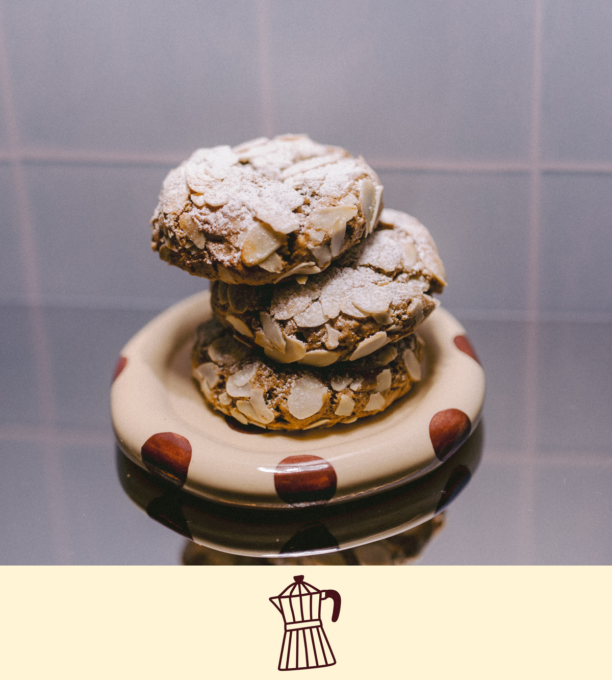 Stack of almond croissant lactation cookies on a polka dot plate with a plain background